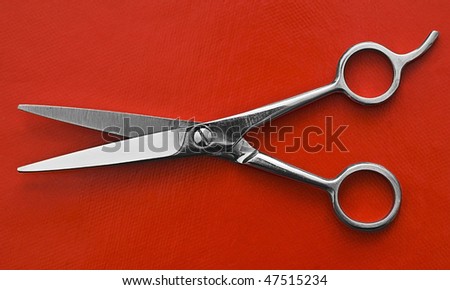 a pair of Scissors on red background