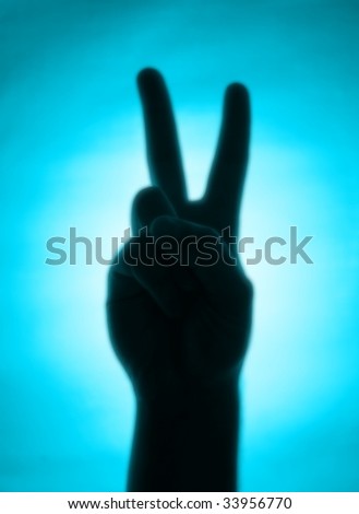 Cyan back-lit hand signaling \'peace\'
