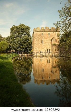 The Bishops palace gate house and moat with reflection