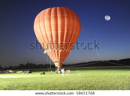 Hot air balloon ride after sunset on a full moon night