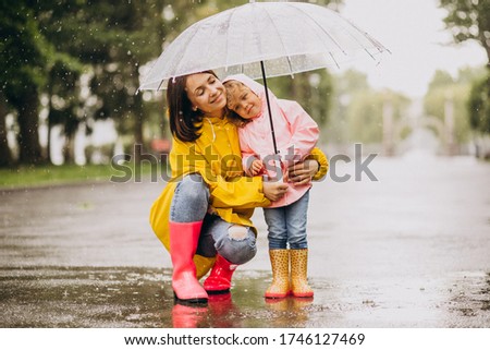 Similar – Image, Stock Photo Cute child under umbrella on rainy day in autumn park