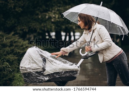 Similar – Image, Stock Photo Stroller in the rain with umbrella