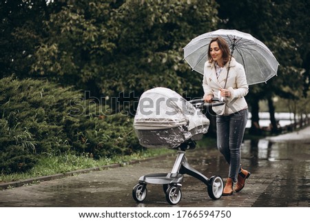 Image, Stock Photo Stroller in the rain with umbrella