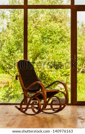 Vintage rocking chair  near a large window