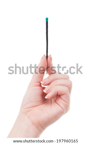 Beautiful female hand holding a wooden match with green phosphorus isolated on white background.