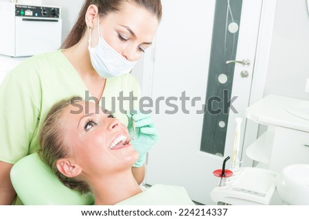 Dental care concept with female dentist and perfect teeth patient