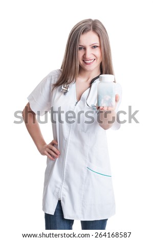 Woman doctor holding a transparent recipient of pills isolated on white background