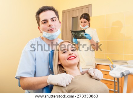 Male dentist doctor and happy female patient with beautiful smile