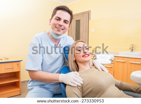 Dentist doctor and patient both smiling relaxed in dental office