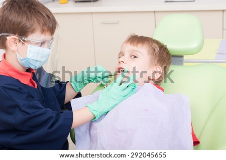Kids playing in dentist office as doctor and patient using tools and equipment