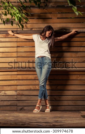 Fashionable and religious concept with female model wearing t-shirt and jeans