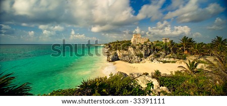 A 110-degree panoramic image of the main temple structure and Gulf of Mexico in the ancient Mayan city at Tulum, Mexico.