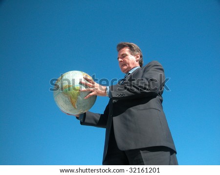 Intent Business man holding globe with both hands