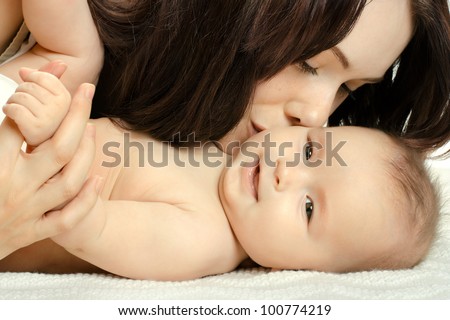 the very  beautiful  little baby with  mother  , close face,  on white background, isolated