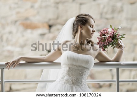 horizontal wedding portrait beautifull  fiancee with  bouquet  in white dress, soft light