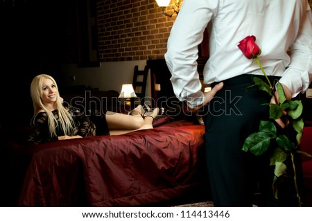 romantic evening date in hotel room, guy with  sexy girl on bed
