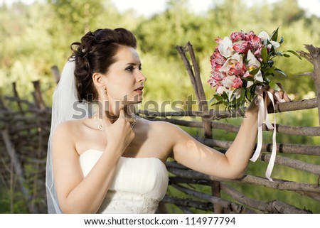 horizontal wedding portrait beautiful  fiancee with  bouquet  in white dress, soft light