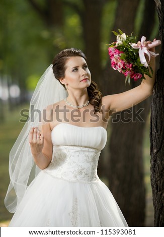 vertical wedding portrait beautiful  fiancee with  bouquet  in white dress