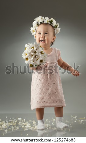 beautiful  little kid with  bouquet and diadem of flowers ,  smile
