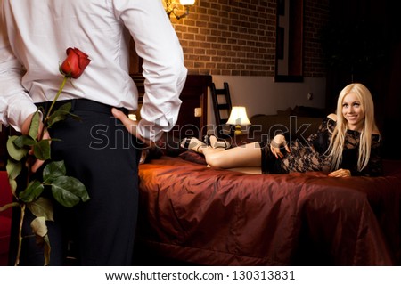 romantic evening date in hotel room, guy with  sexy girl on bed