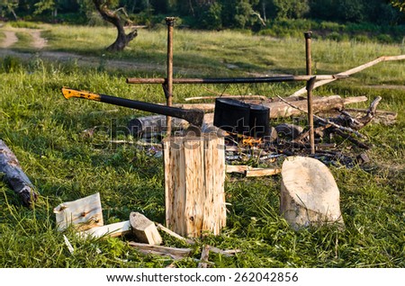 chopper and fuelwood, campfire and food on halt in walking tour