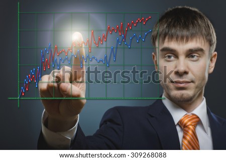 handsome businessman with diagram, finger point touch, on dark grey background