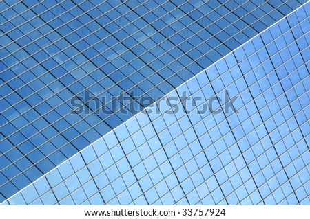 Part of a dark blue glass facade of a skyscraper, for a background