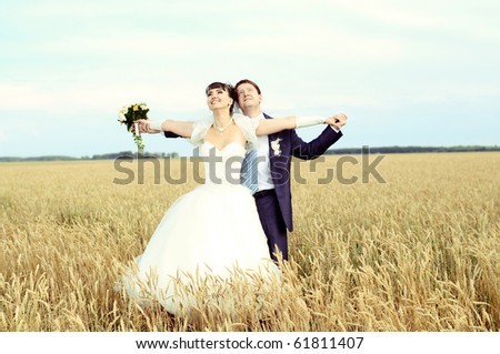 cutie happy married  couple  on nature, on wheaten field,  embrace and smile