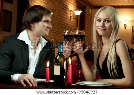 romantic evening date in hotel room, or supper in restaurant, happy couple with wine glass