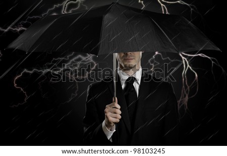 portrait  man the  beautiful  man in black costume with blak umbrella,  special-service agent or  guard
