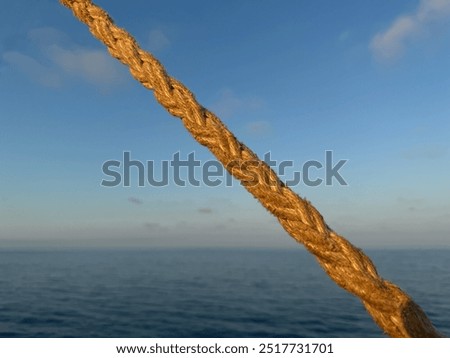 Image, Stock Photo a taut rope on the beach holding up a boat