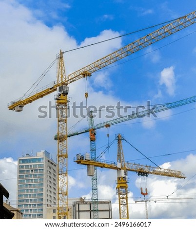 Similar – Image, Stock Photo Construction cranes with street lamp in front of a blue sky