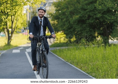 Similar – Image, Stock Photo Cheerful manager with bicycle talking on smartphone