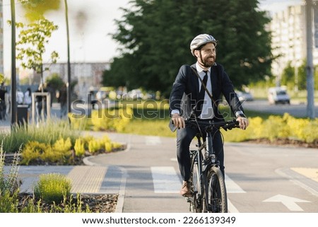 Similar – Image, Stock Photo Cheerful manager with bicycle talking on smartphone