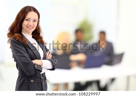 Beautiful businesswoman keeps the laptop. Isolated on a white background.