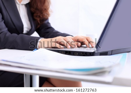 Business woman in the office, work at the computer, close-up.