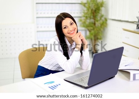Nice business woman in the office for work with the computer.