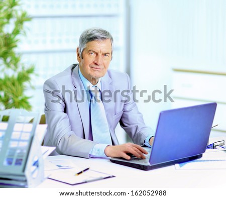 The businessman at the age of works for the laptop.
