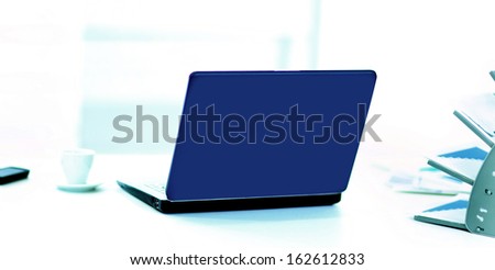 Demonstration of a laptop in the office of the rear view.