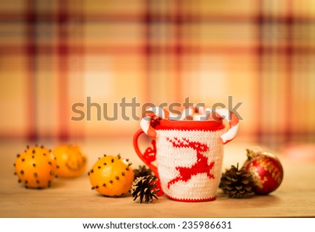 insulated wool cloth mug with embroidered deer on the wooden table mug with tangerines and a candy