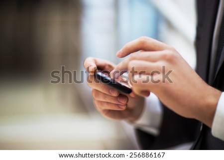 Young businessman working with modern devices, digital tablet computer and mobile phone.