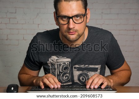 Man sitting in front of his computer, programming.