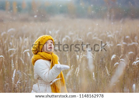 Similar – Image, Stock Photo A little girl catches soap bubbles in the park, sitting on the grass. The concept of a happy childhood
