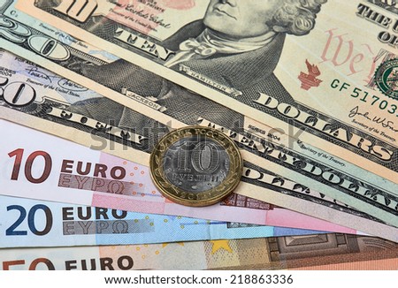 Fanned out banknotes of euros, dollars and Russian coin. Closeup.