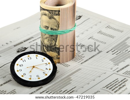 Closeup of roll bills of money on business newspaper for the concept of time and money. Isolated on the white