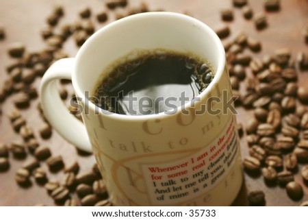 Cup of coffee set against a backdrop of coffee beans. Shallow DOF.