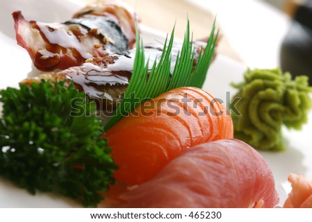 Fresh tuna, atlantic salmon and jumbo shrimp individually hand pressed with rice. Served with wasabi sauce. Shallow DOF.