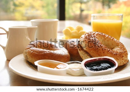 Classic breakfast of coffee, toasted bagels with butter and orange juice