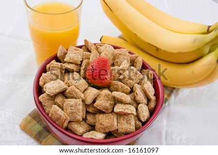 Breakfast Series - A nutritious bowl of shredded wheat squares, orange juice and bananas.