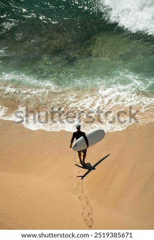 Similar – Image, Stock Photo Surfer entering into the water with his surfboard.